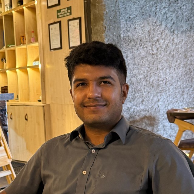 Aashish K C, smiling, in a café in Kathmandu